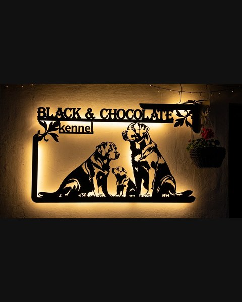 Black & Chocolate kennel sign with warm LED lighting at night