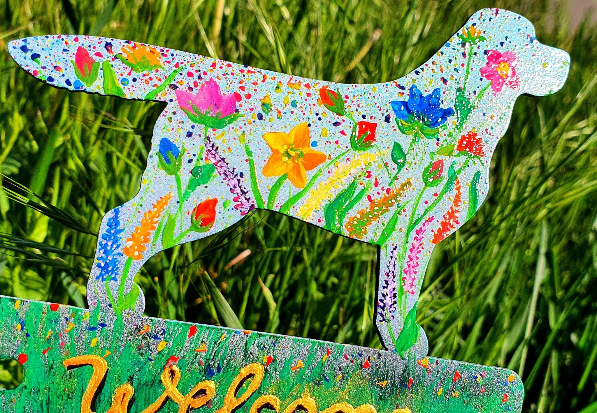 Close-up of floral painting on a light-coloured metal dog silhouette