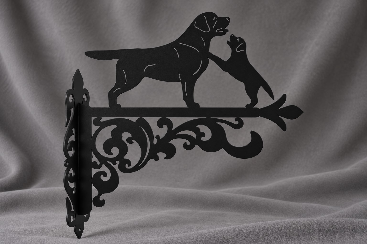 Full view of the black Labrador mother and puppy bracket on a grey background