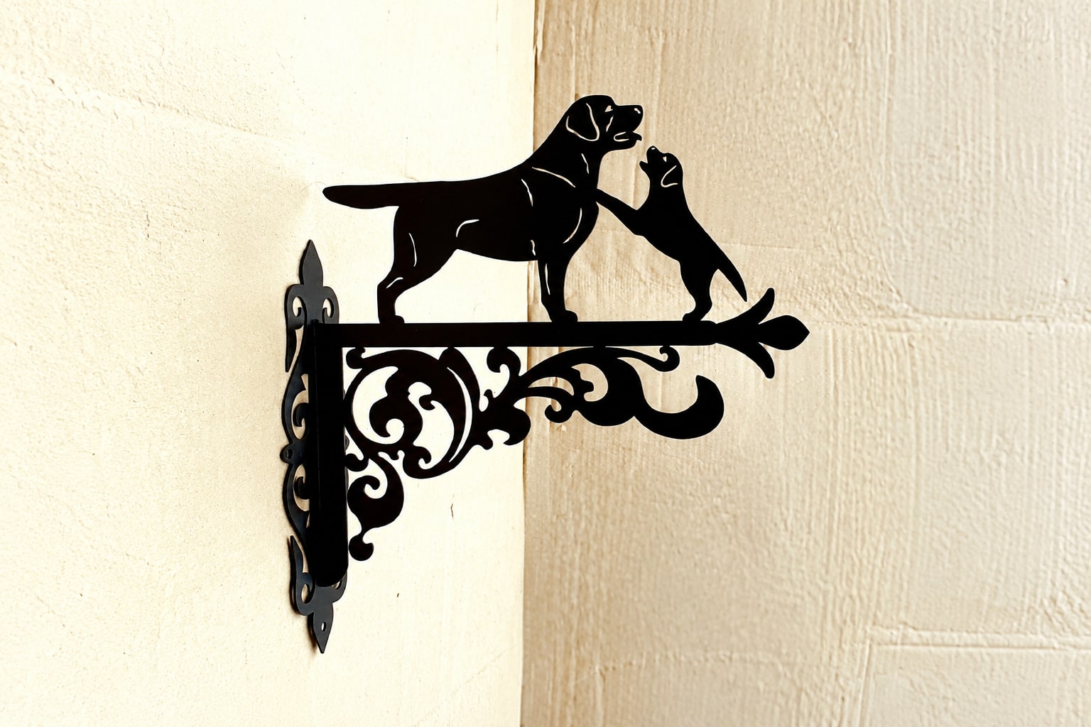Decorative Labrador mother and puppy bracket mounted on a light wall