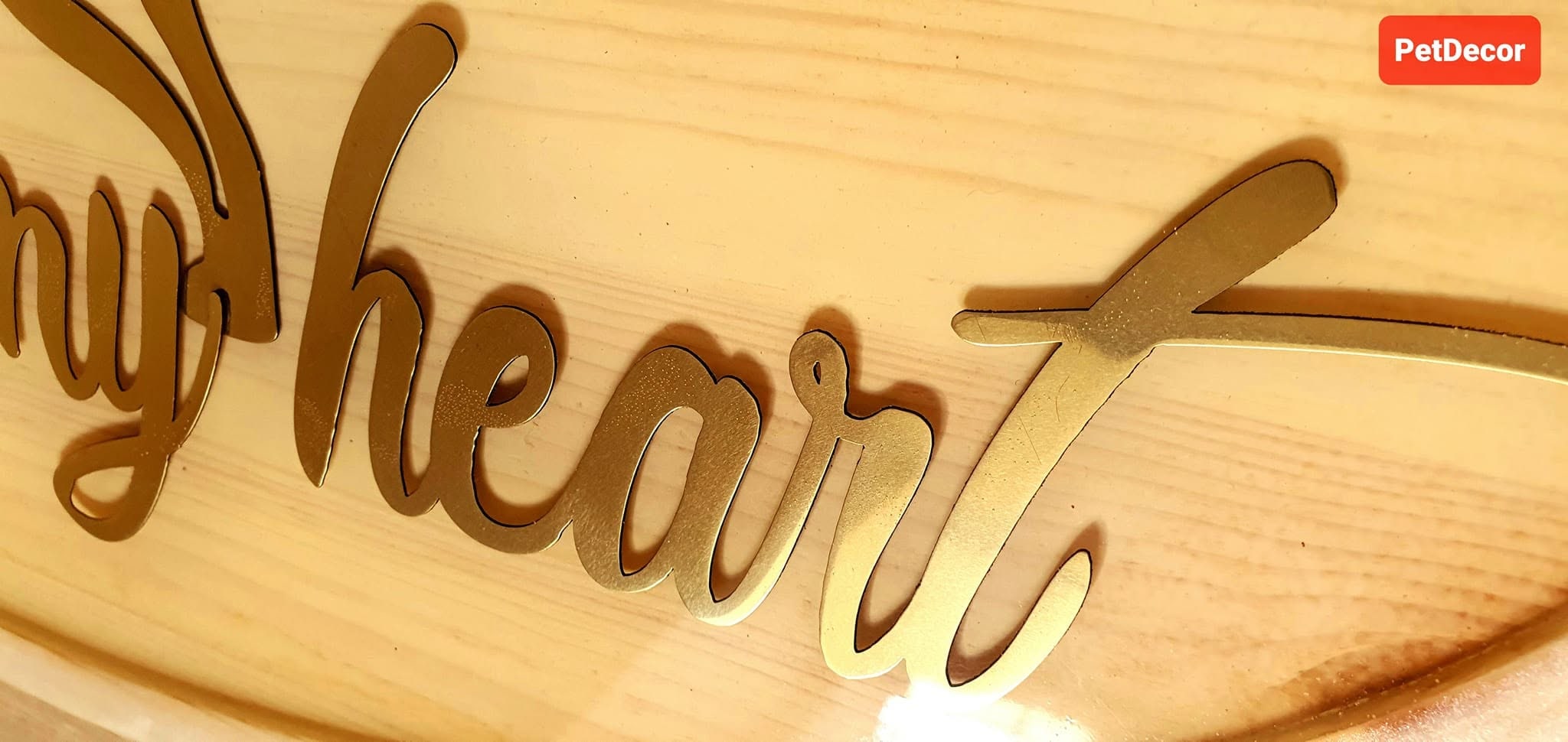 Close-up of Sun of My Heart brass lettering embedded in clear epoxy resin